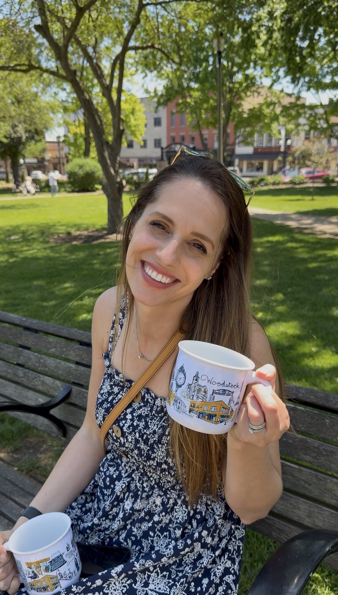 Artist Ashley Ann holding The Woodstock Mug in Woodstock Square