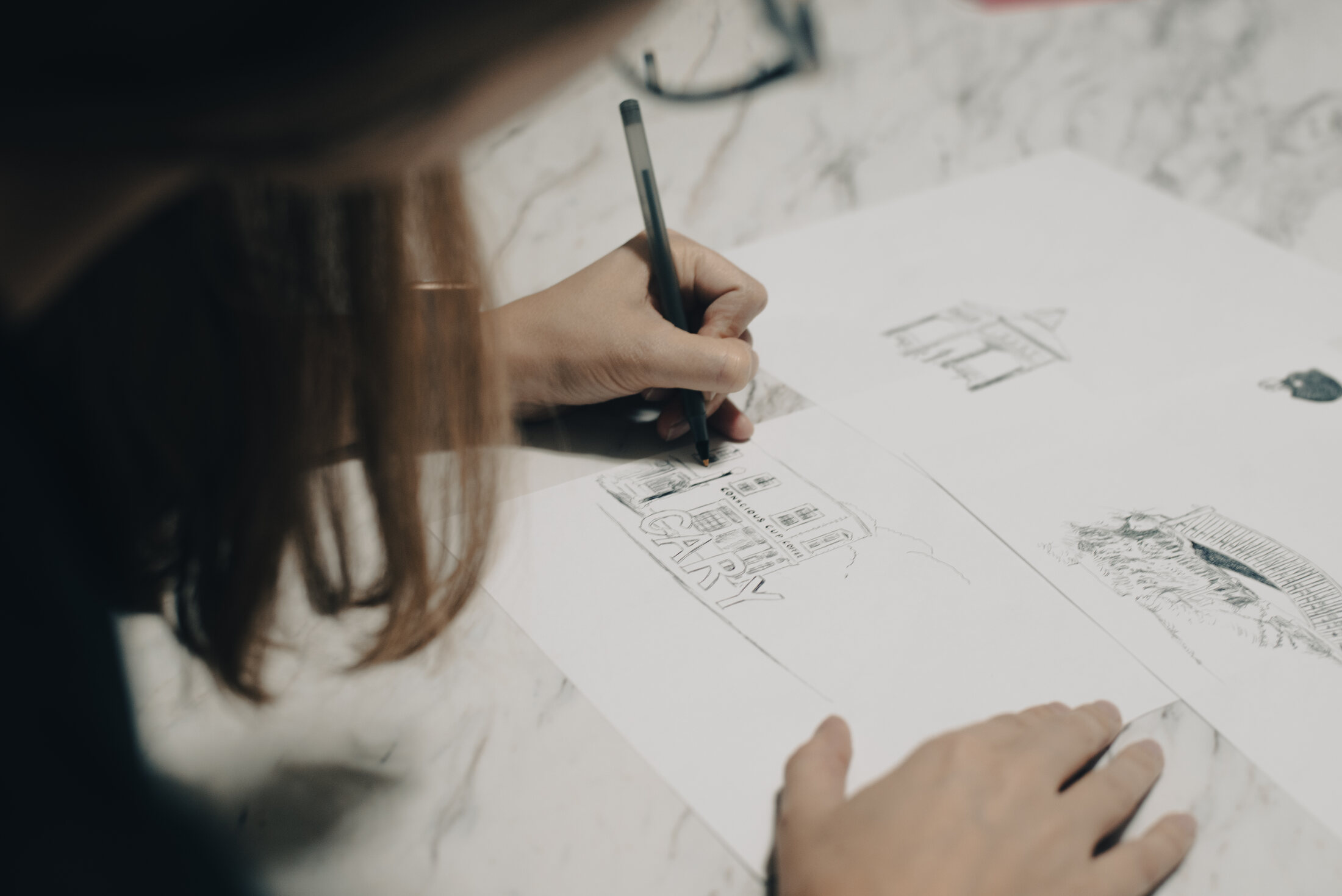 Ashley Ann hand drawing artwork for The Cary Mug