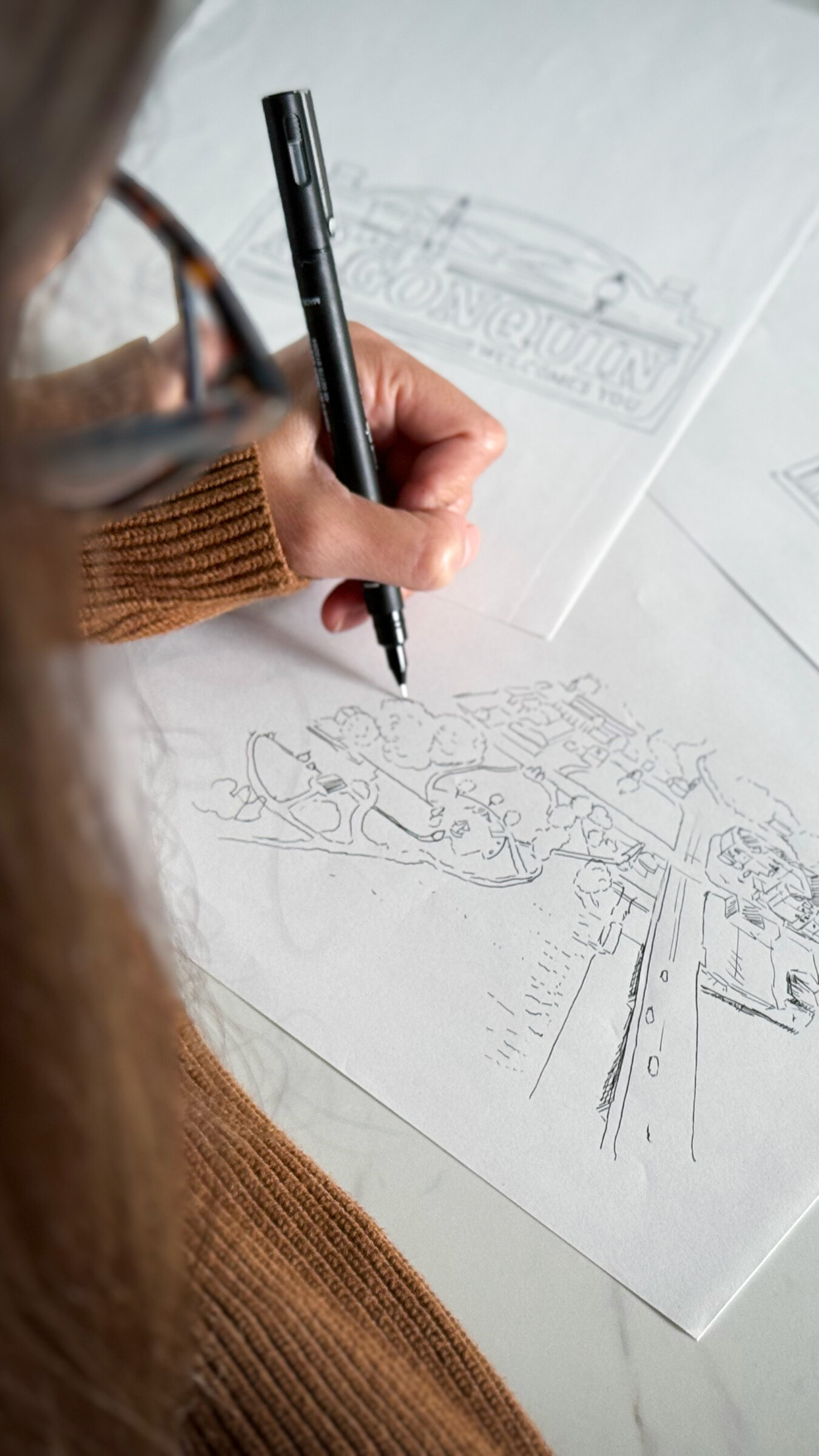 Ashley sketching the Algonquin mug artwork on paper