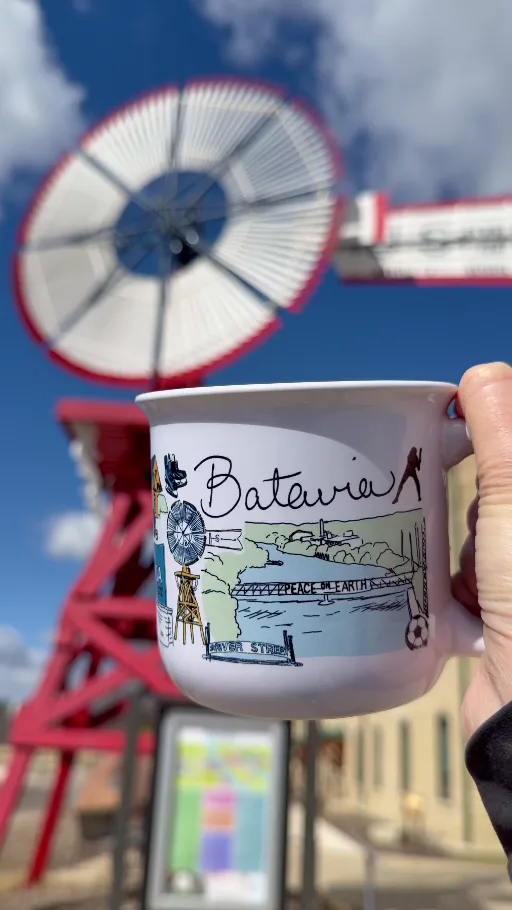 The Batavia Mug held beside a downtown windmill