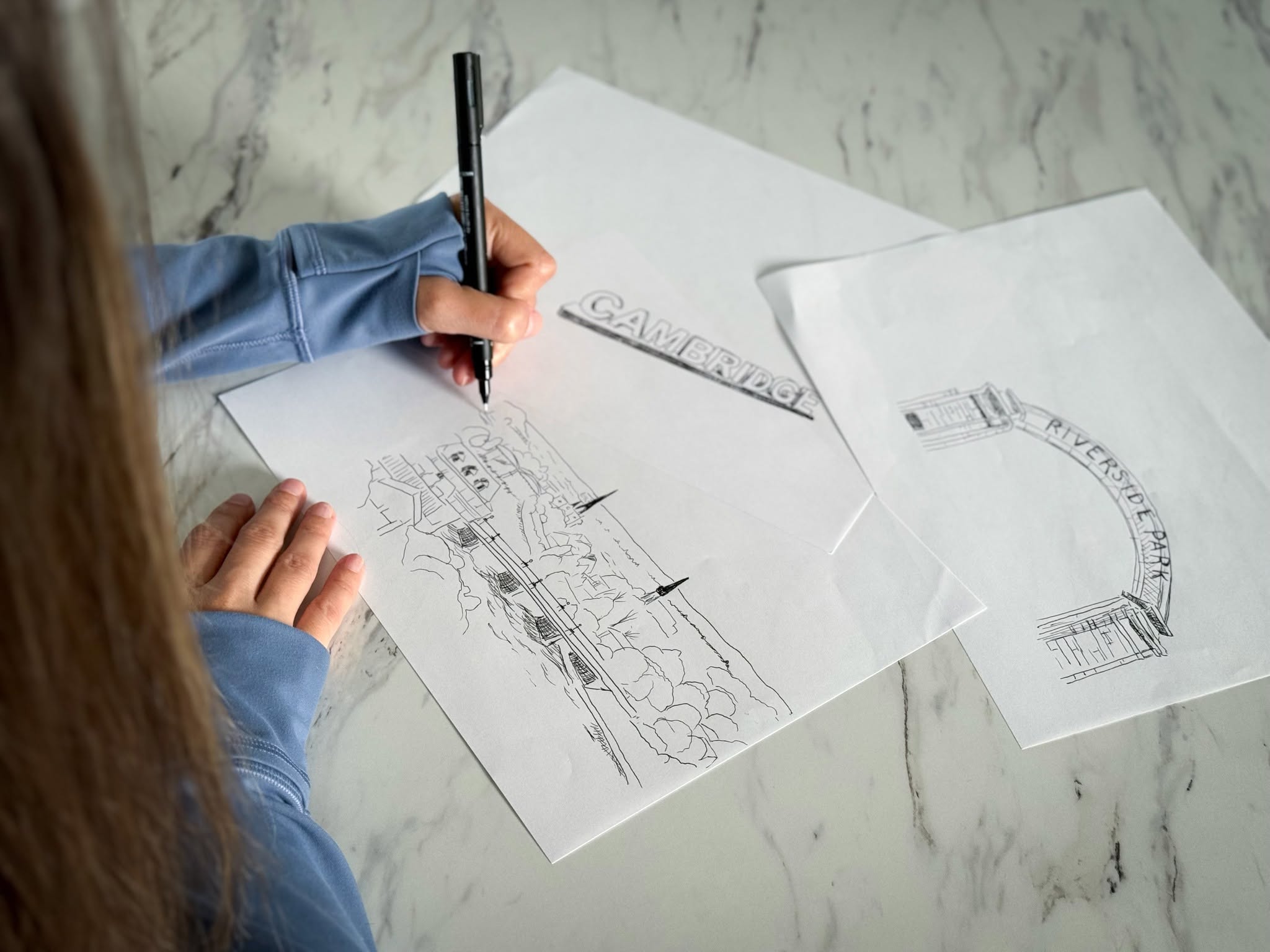 Ashley Ann drawing landmarks for The Cambridge Mug by hand