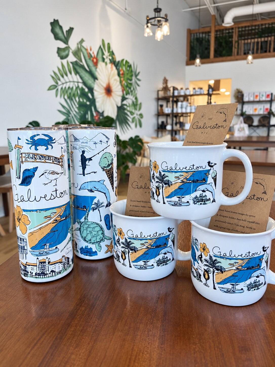 Galveston mugs and tumblers displayed inside Seawall Coffee